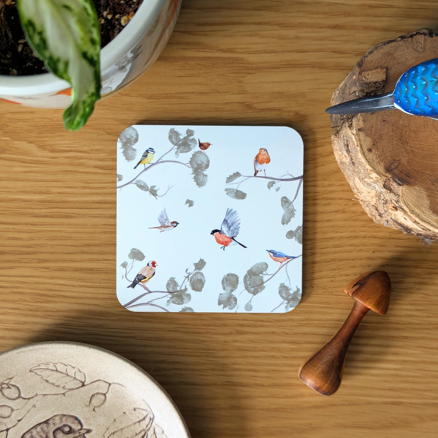 garden bird coaster with a robin, wren, sparrow, blue tit, nuthatch, bullfinch and goldfinch