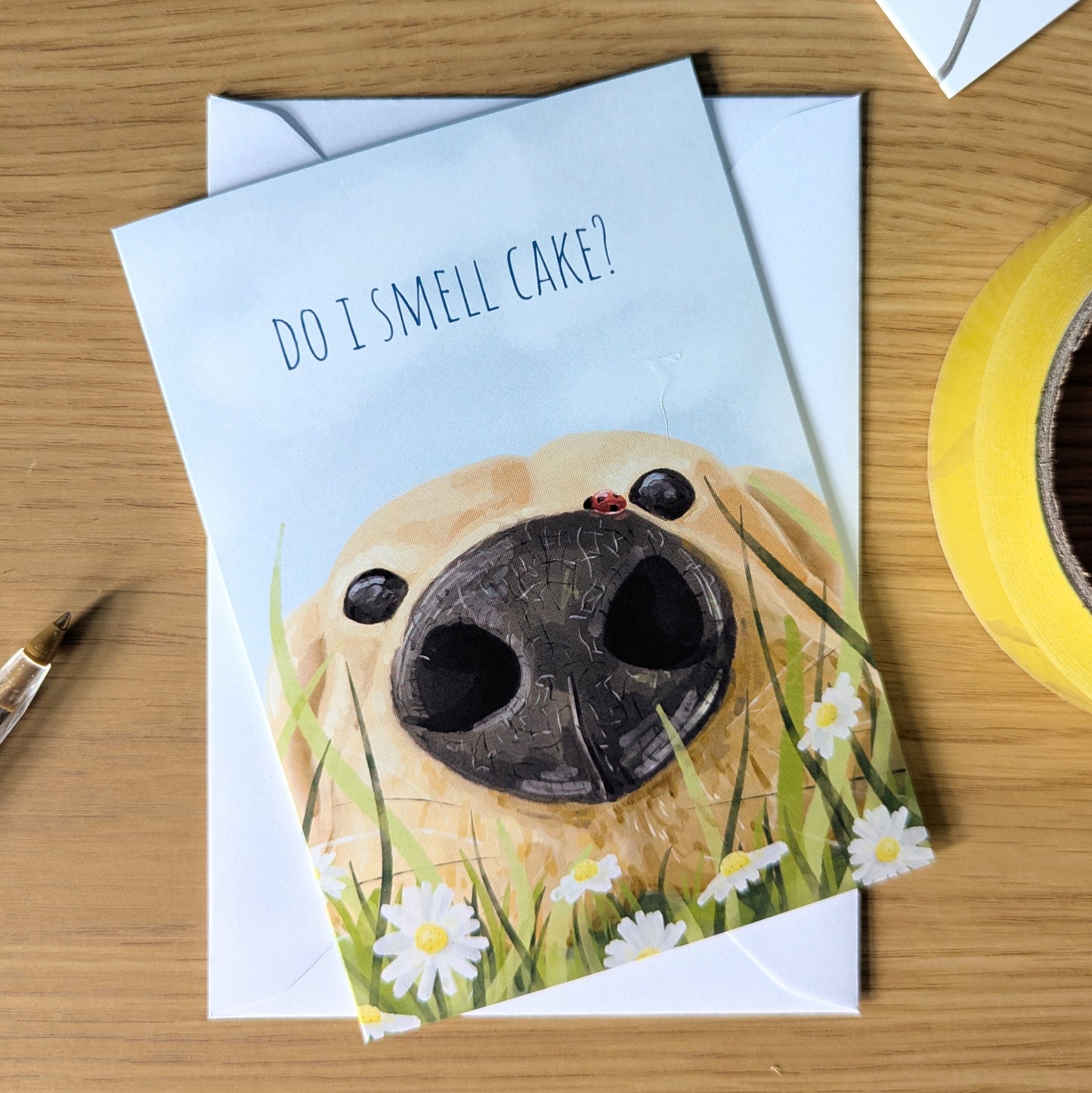 A fantastic choice for a birthday card from the dog, featuring a close up of a Labrador nose amongst daisies with the message - Do I smell cake? Perfect card for Labrador owners