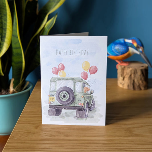 green land rover defender birthday card with a dog out of the window