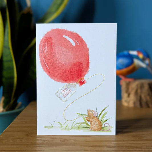 whimsical mouse birthday card featuring a little mouse holding a red balloon with a tag that says happy birthday