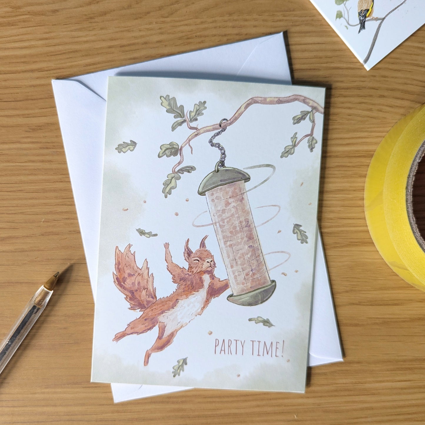 This funny red squirrel birthday card features our iconic British red squirrel who is cheekily swinging around a full bird feeder, with the message - party time. Perfect gifts for UK wildlife lovers
